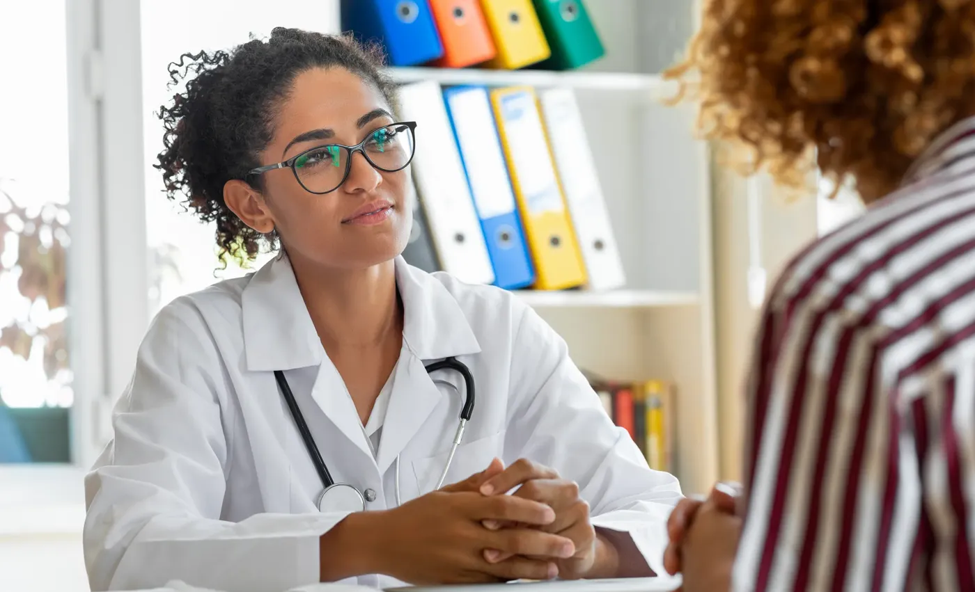 Addiction treatment center employee speaks with a patient.