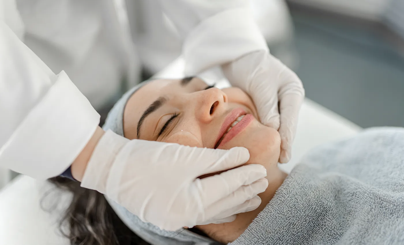 Plastic surgeon checking patients face for healing.